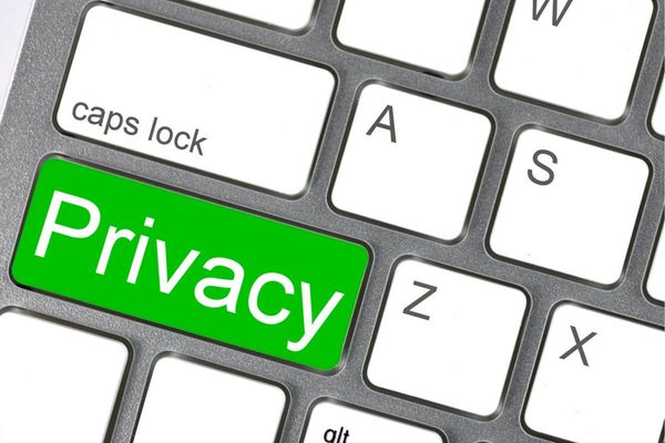 A computer keyboard with an extra "privacy" key, in green right below the caps lock key
