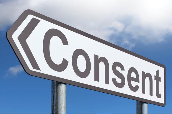 A highway sign, in the shape of an arrow, with the word Consent.