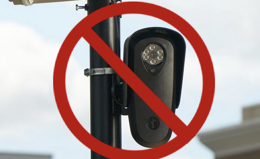 A flock surveillance camera, with a big red circle and slash over it